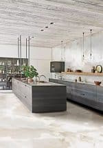 Abstract Pearl onyx-look porcelain floor in a kitchen with a dark island
