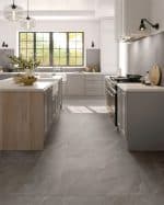 Fumo stone-look porcelain floor in a kitchen with a timber island